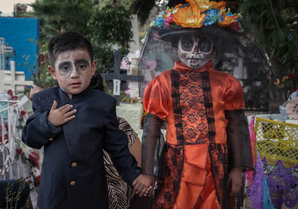 Two kids as catrinas in the cemetery in Ajijic, Mexico.