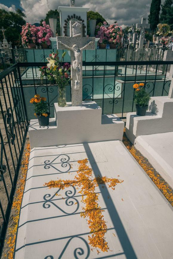Cempásuchil flowers form a cross on a grave in Chapala.