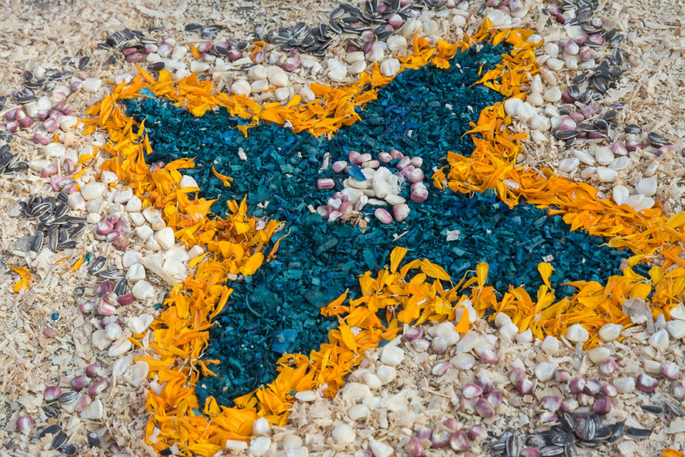 Sunflower seeds, purple and white corn, marigold petals, and sawdust form an all-natural design at an altar on November 2, 2017, in Chapala, Jalisco, Mexico