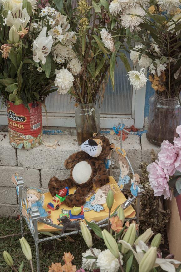 A child's stuffed animal and other toys on his grave on the Día de los Angelitos, which takes place on November 1 as part of the Days of the Dead.
