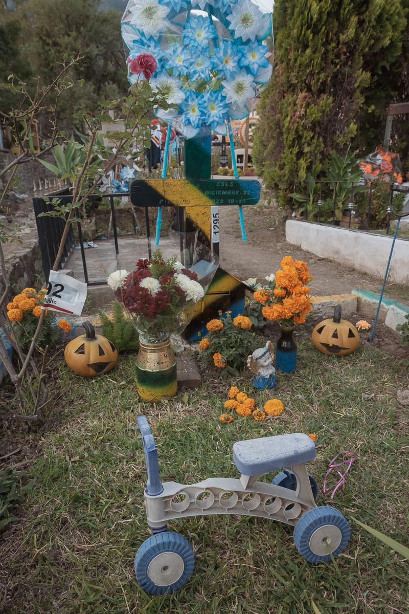 A child's toy sits on a grave for a child on el Día de los Angelitos which is part of the Days of the Dead and takes place on November 1.
