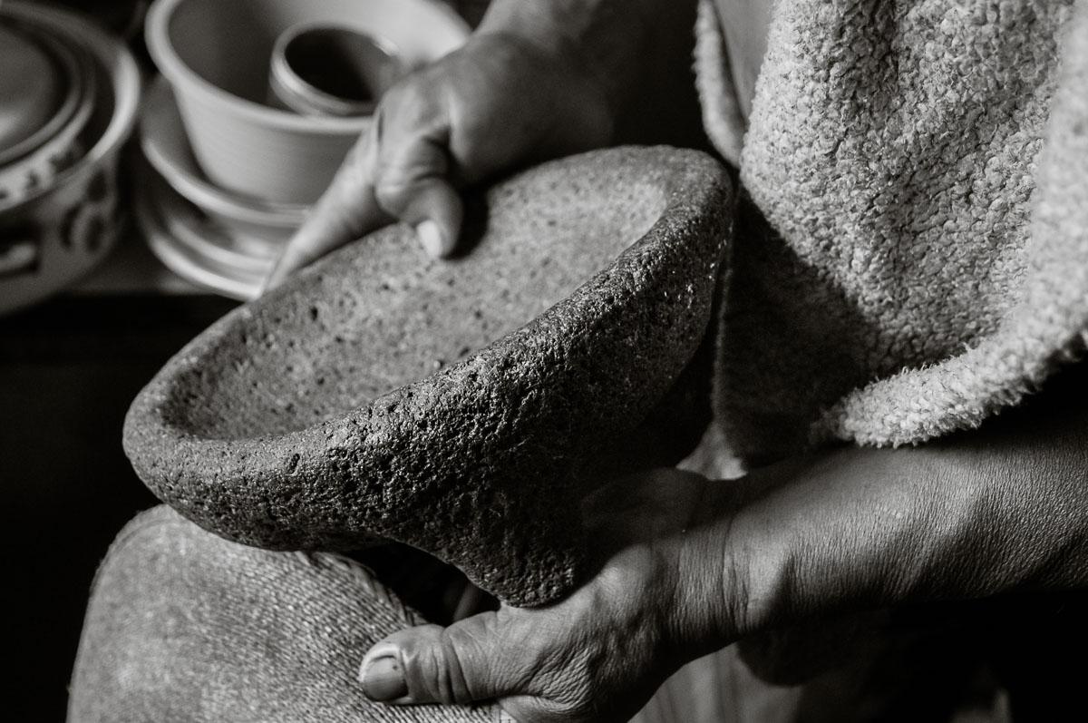 Ismael Sánchez holds a molcajete in his kitchen in Ajijic, Jalisco
