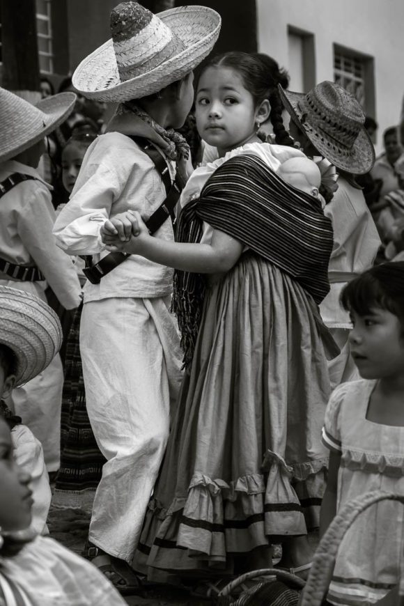 Kids dance in the street dresses as little Mexican revolutionaries on Revolution Day in Ajijic.