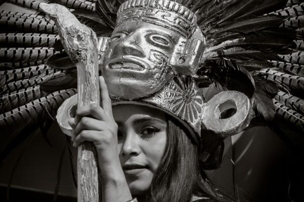 A young woman as an Aztec goddess stands on a moving float during the 2015 New Year's Day parade in Ajijic, Jalisco, Mexico