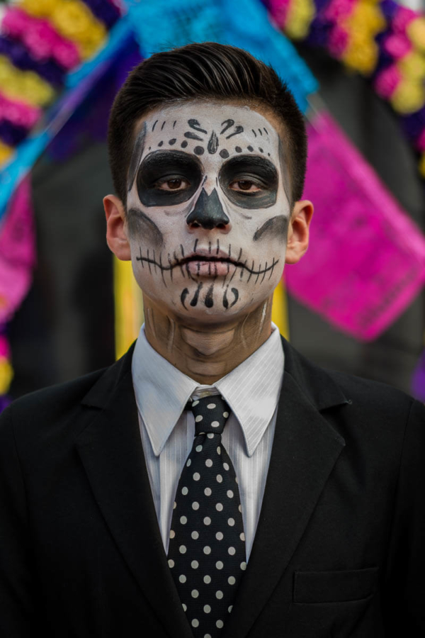 A young man dressed as a catrine on the Day of the Dead in Chapala, Jalisco. The catrina (feminine) or catrine has been a part of the Day of the Dead traditions since Mexican printmaker José Guadalupe Posada created his 1910 etching La Calavera Catrina. The etching of a skeleton sporting elegant dress the catrina is not only an iconic part of the Day of the Dead, but one of Mexico's most identifying aspects.