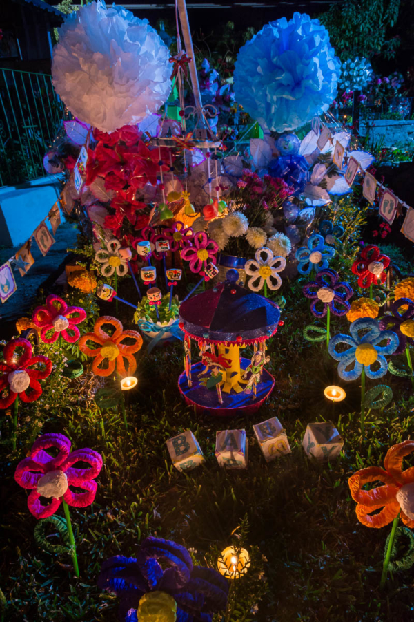 Handmade decorations light up an altar for a baby on a tomb in the Ajijic, Jalisco, graveyard.