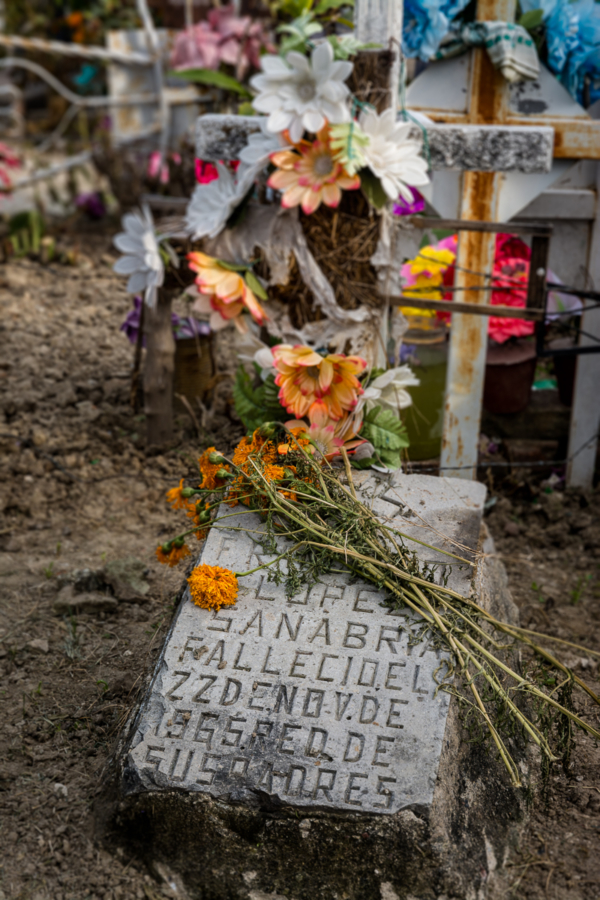 Marigolds left on and old headstone in the graveyard in Chapala, Jalisco.