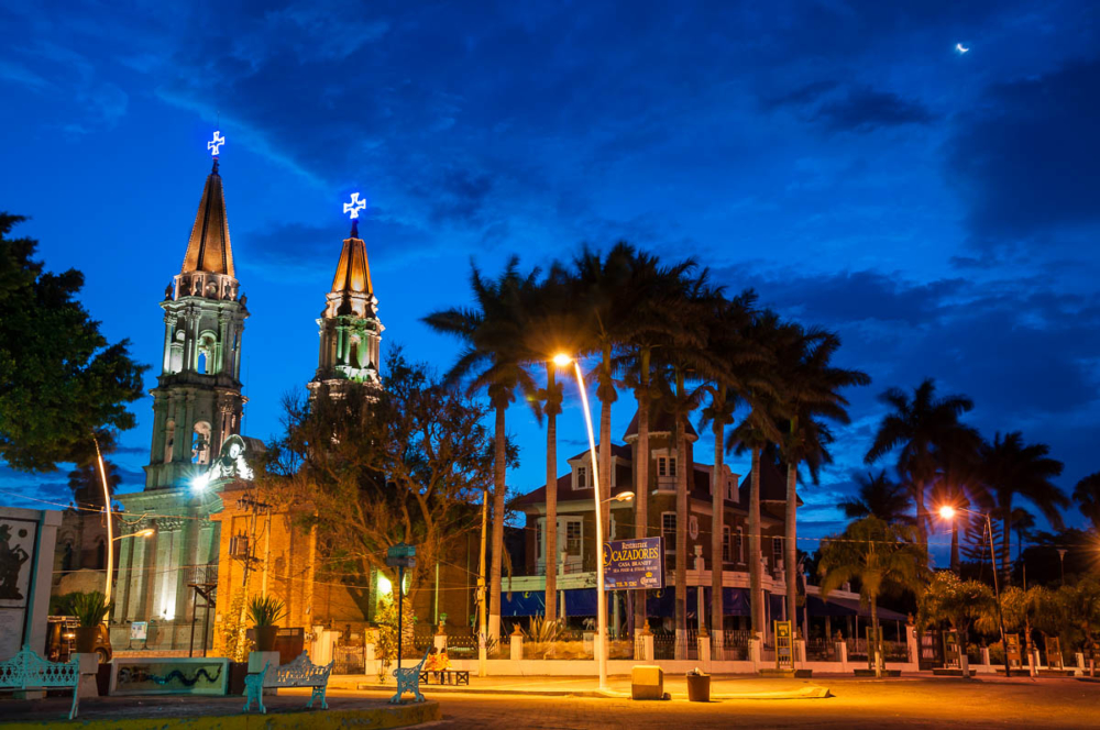 After 14 days, twilight breaks behind the twin spires of the church in Chapala, Jalisco, Mexico.