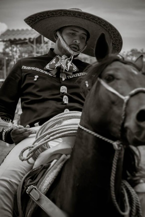 A cowboy plays a game of darts on horseback during the Day of the Cowboy.