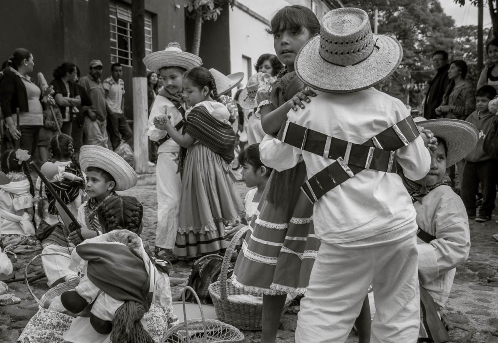 Kids, dressed as Mexican revolutionary heroes, dance in the street during the parade in Ajijic, Jalisco, Mexico.