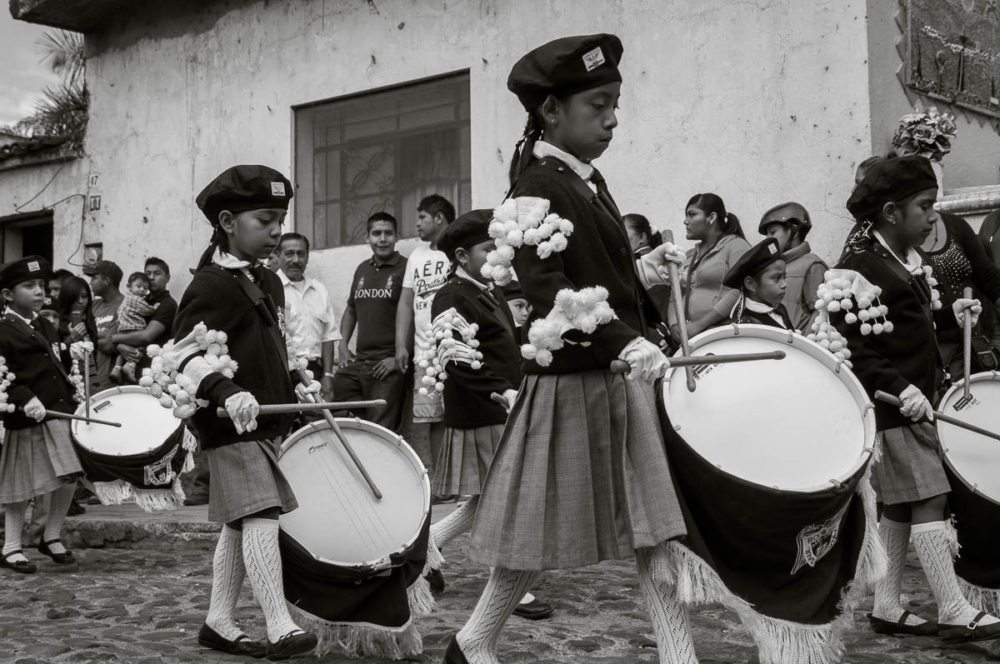 Girls play the snare drum in a youth marching band during the parade.