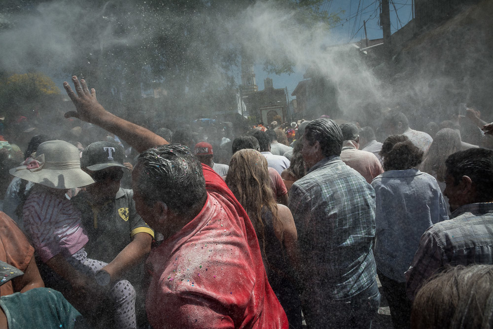 Parade-goers throw flour during Carnaval in Ajijic, Jalisco, Mexico.