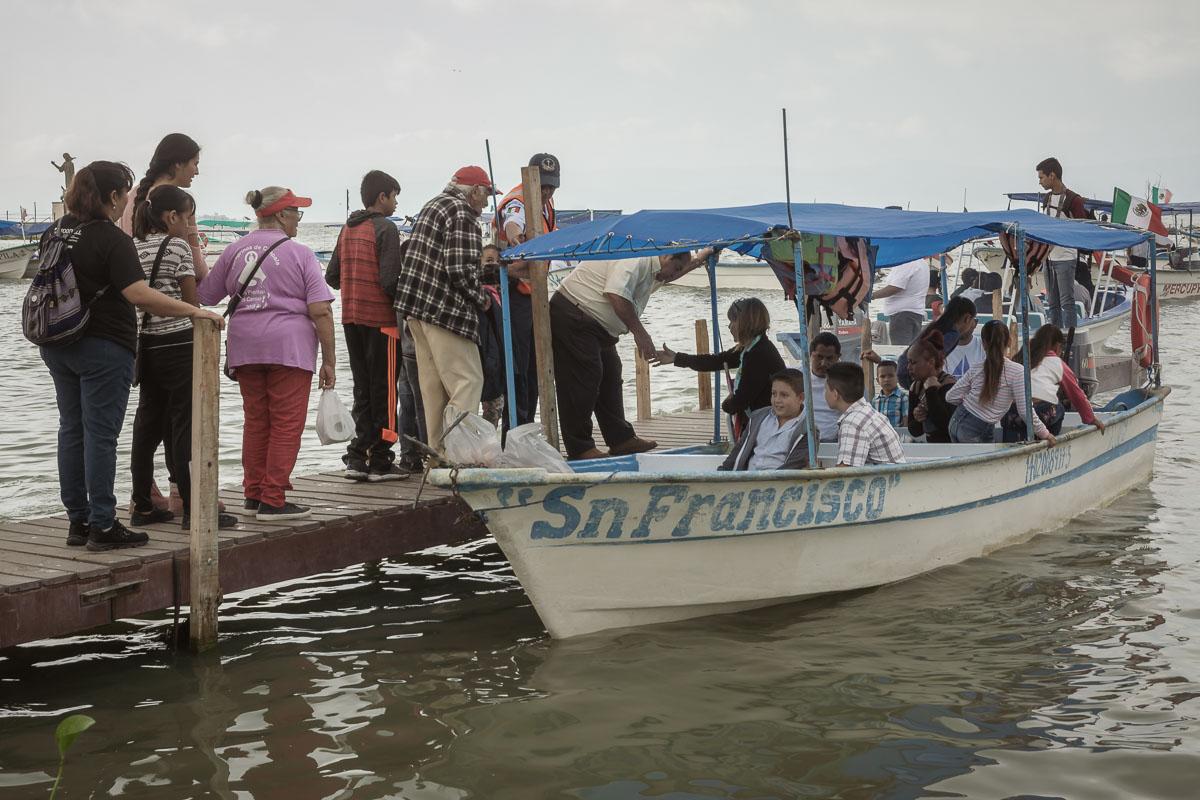 People board the boat "Sn (San) Francisco," who is the city of Chapala's patron saint, Francis.